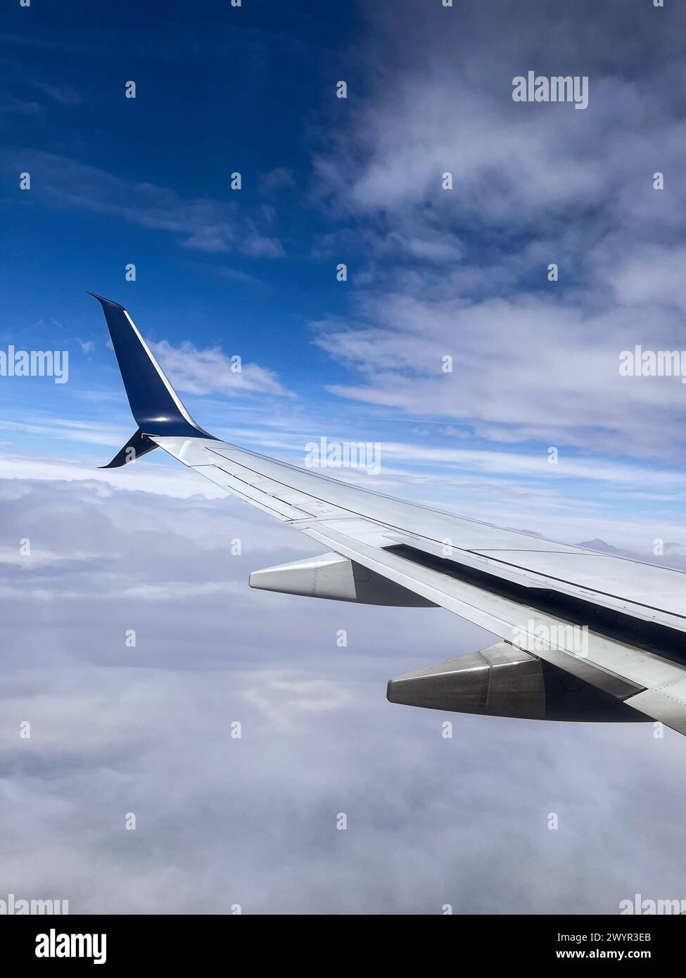 Wing of an airplane in the blue sky Stock Photo