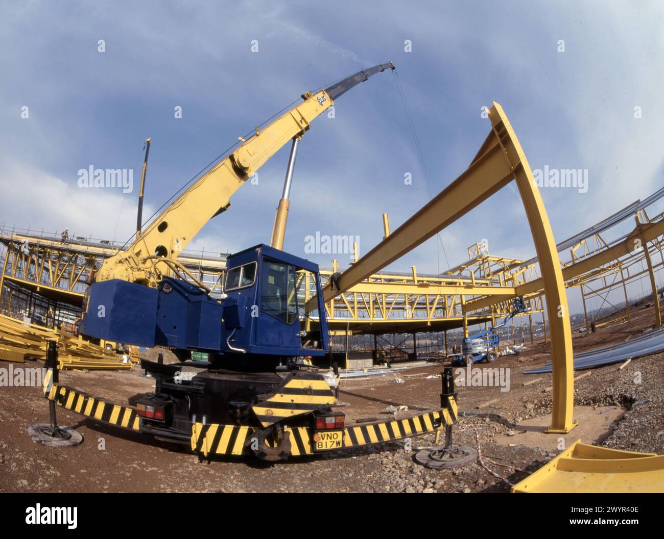 Steel frame construction operations for supermarket development, crane photographed using fisheye lens Stock Photo