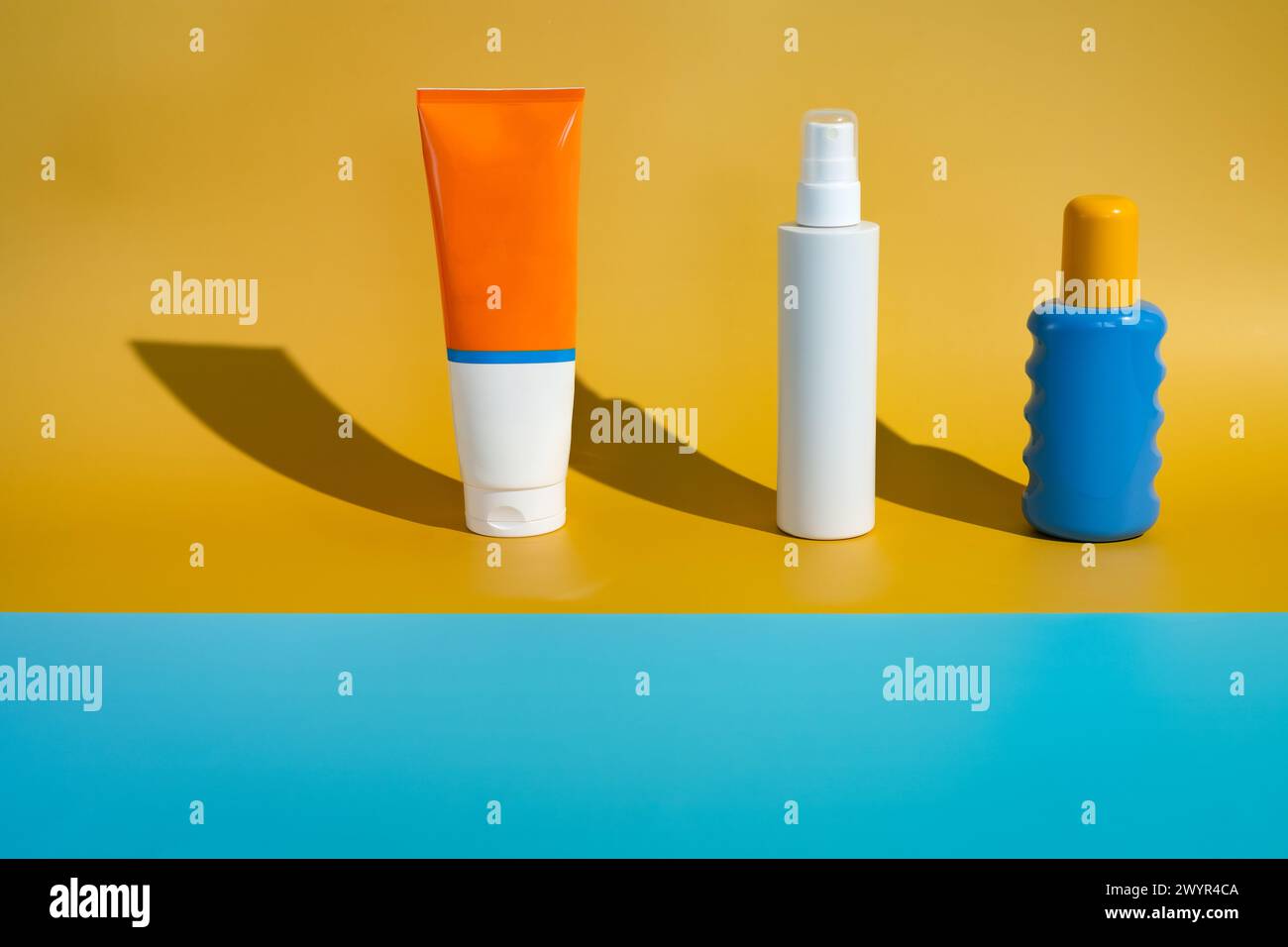 Different blank sunscreen packaging bottles on minimalist beach of ...