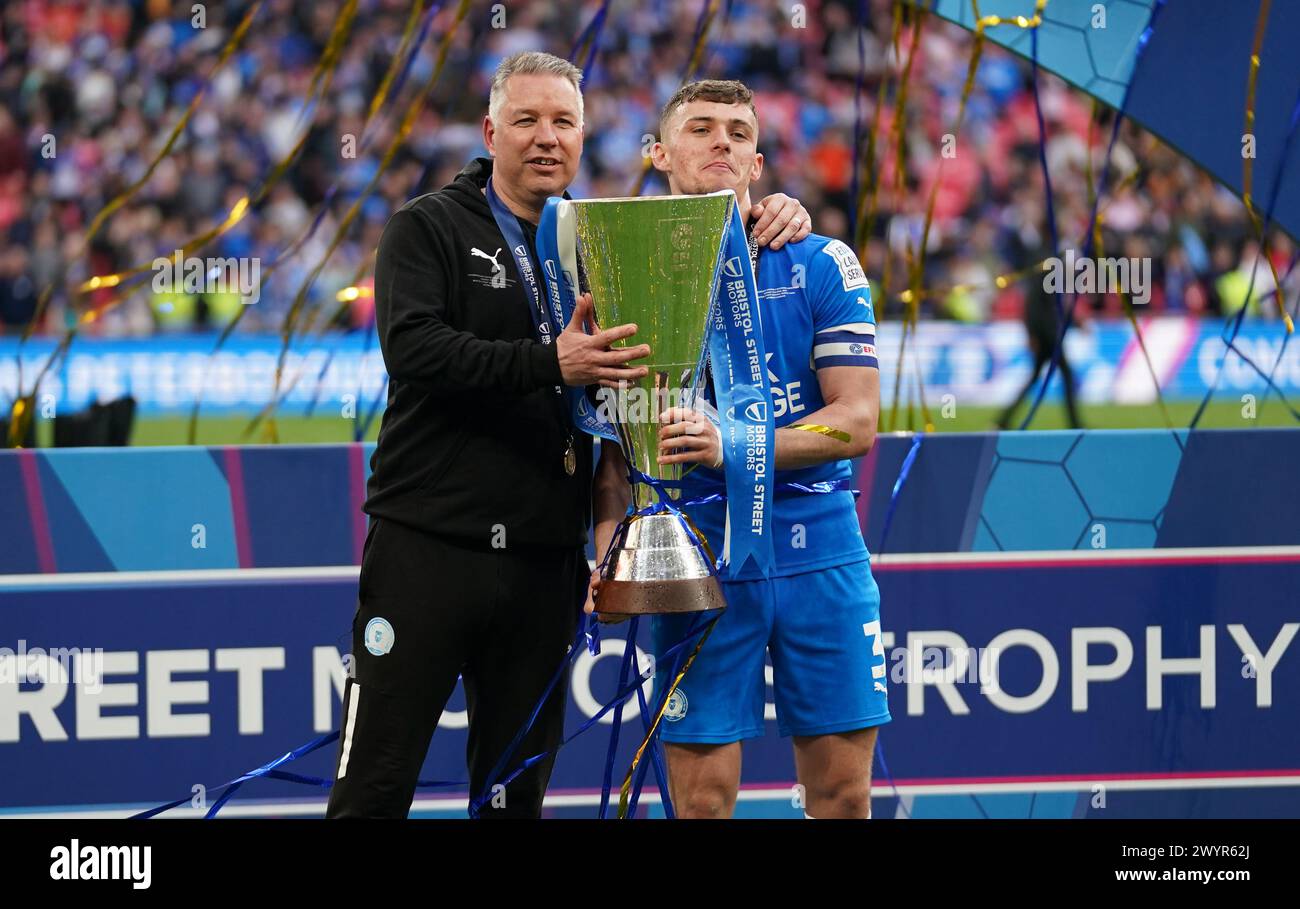 LONDON, ENGLAND - APRIL 7: Darren Ferguson, Manager of Peterborough United and Harrison Burrows of Peterborough United with the EFL Trophy after the Bristol Street Motors Trophy Final between Peterborough United and Wycombe Wanderers at Wembley Stadium on April 7, 2024 in London, England. (Photo by Dylan Hepworth/MB Media) Stock Photo
