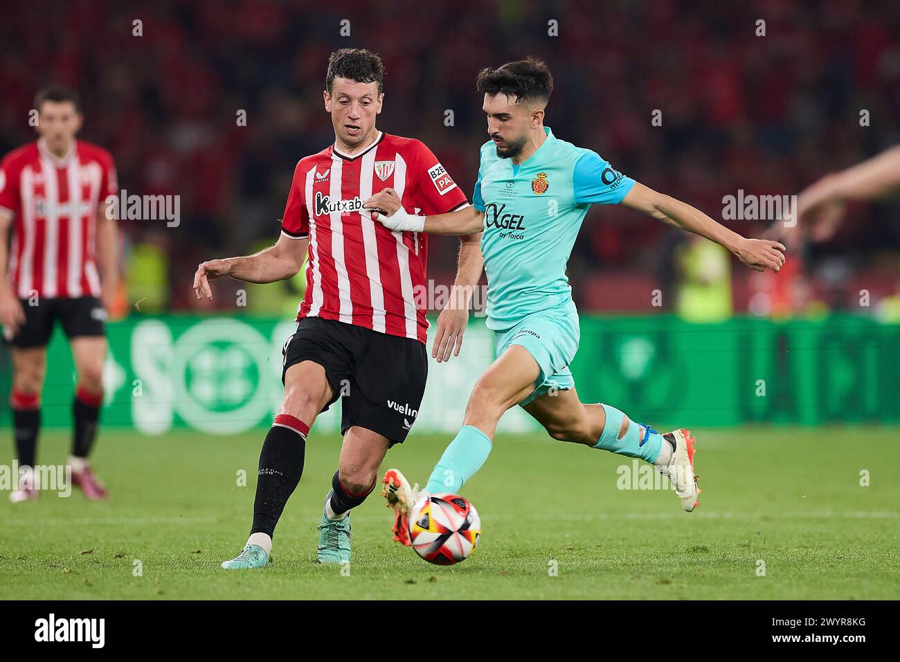 Mikel Vesga (L) of Athletic Club and Manuel Morlanes Ariño, known as Manu Morlanes (R) of RCD Mallorca seen in action during the 2024 Copa del Rey final between Athletic Club and Mallorca at Estadio La Cartuja de Sevilla. Final scores; Athletic Club 1:1 Mallorca. (Penalties: 4:2) Stock Photo