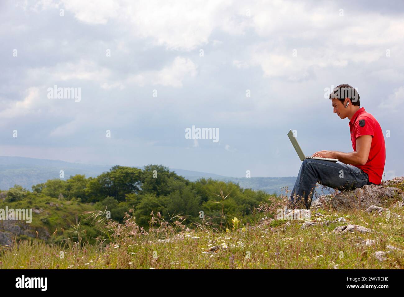 Young man using laptop computer, Murguia, Alava, Euskadi, Spain. Stock Photo