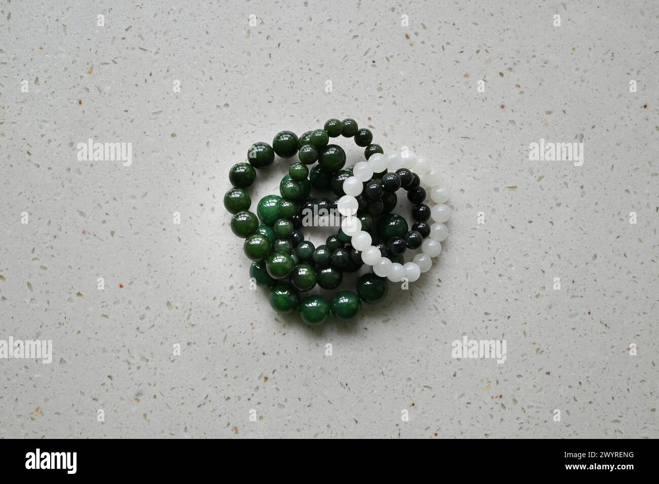 green and white bracelet on the table Stock Photo