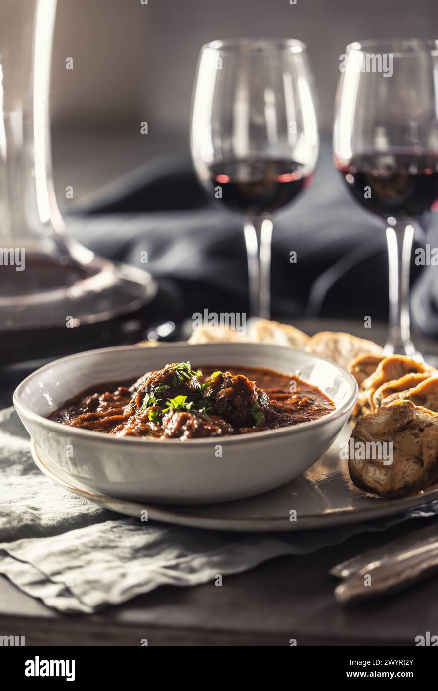Traditional Viennese, venison or Hungarian goulash with Karlovy Vary dumplings and red wine. Stock Photo