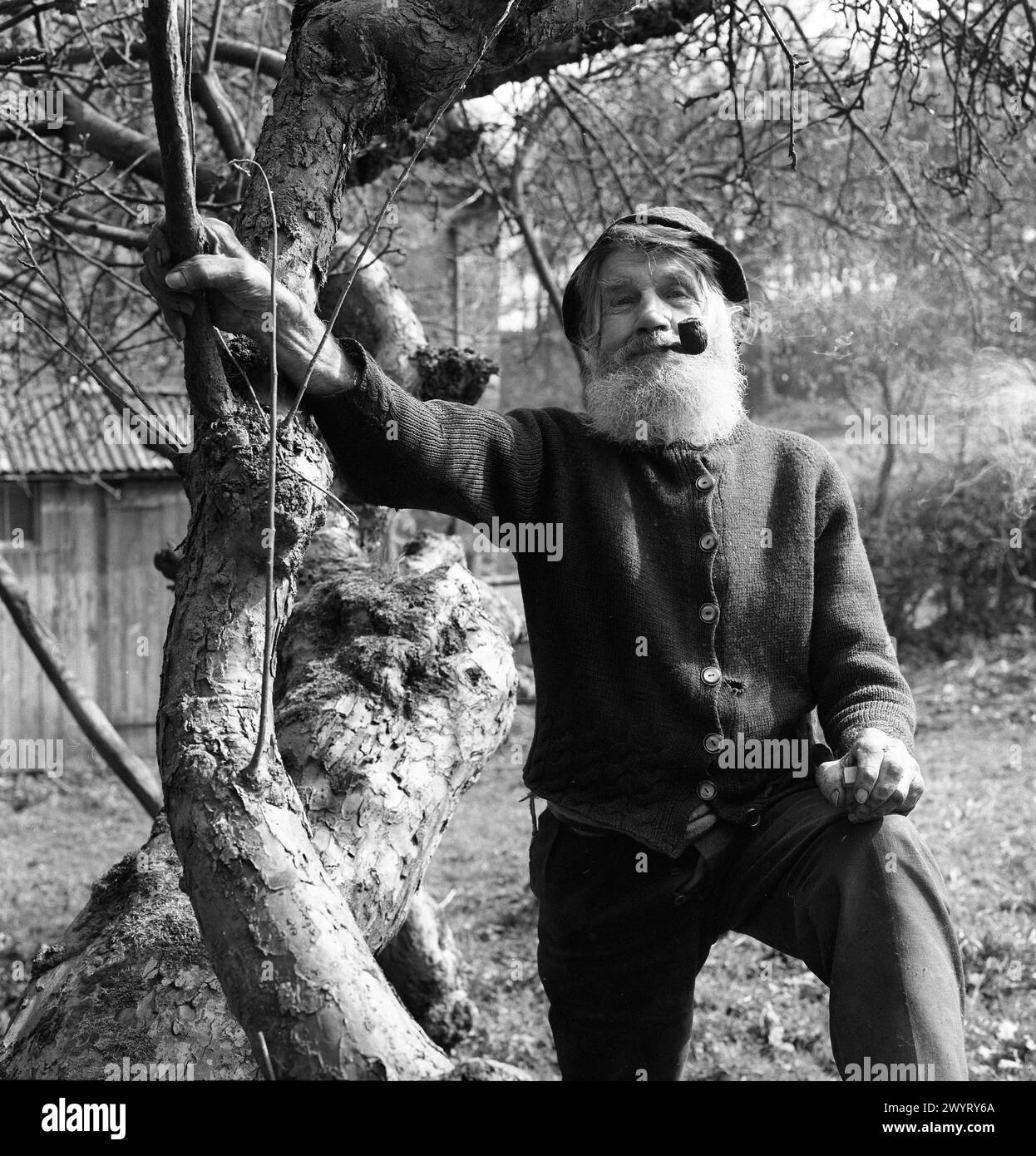 Old man called Joe Morris smoking pipe at Linley Brook near Broseley