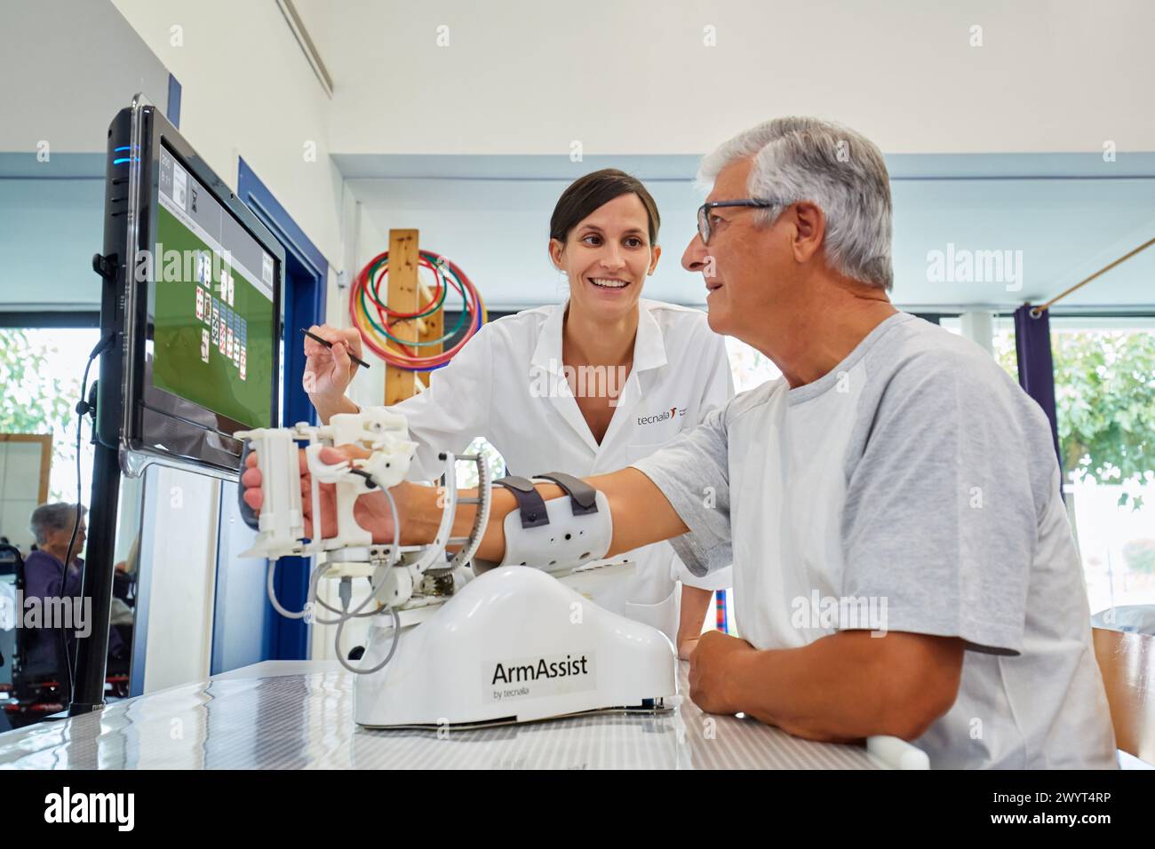 Therapist and patient with assistive robot for upper limb ...