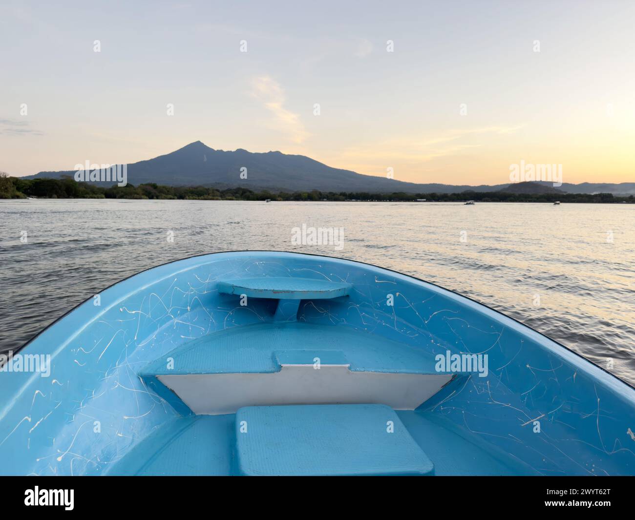 Empty blue boat bow on nature background in sunset time Stock Photo