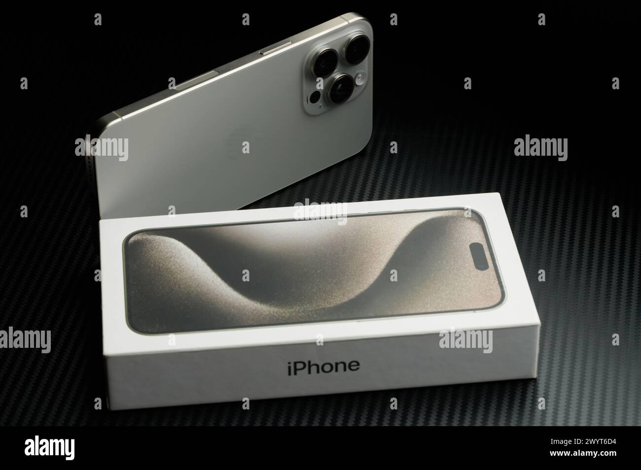 New York, USA - January 23, 2024: New generation of Apple Iphone with box on black studio background Stock Photo