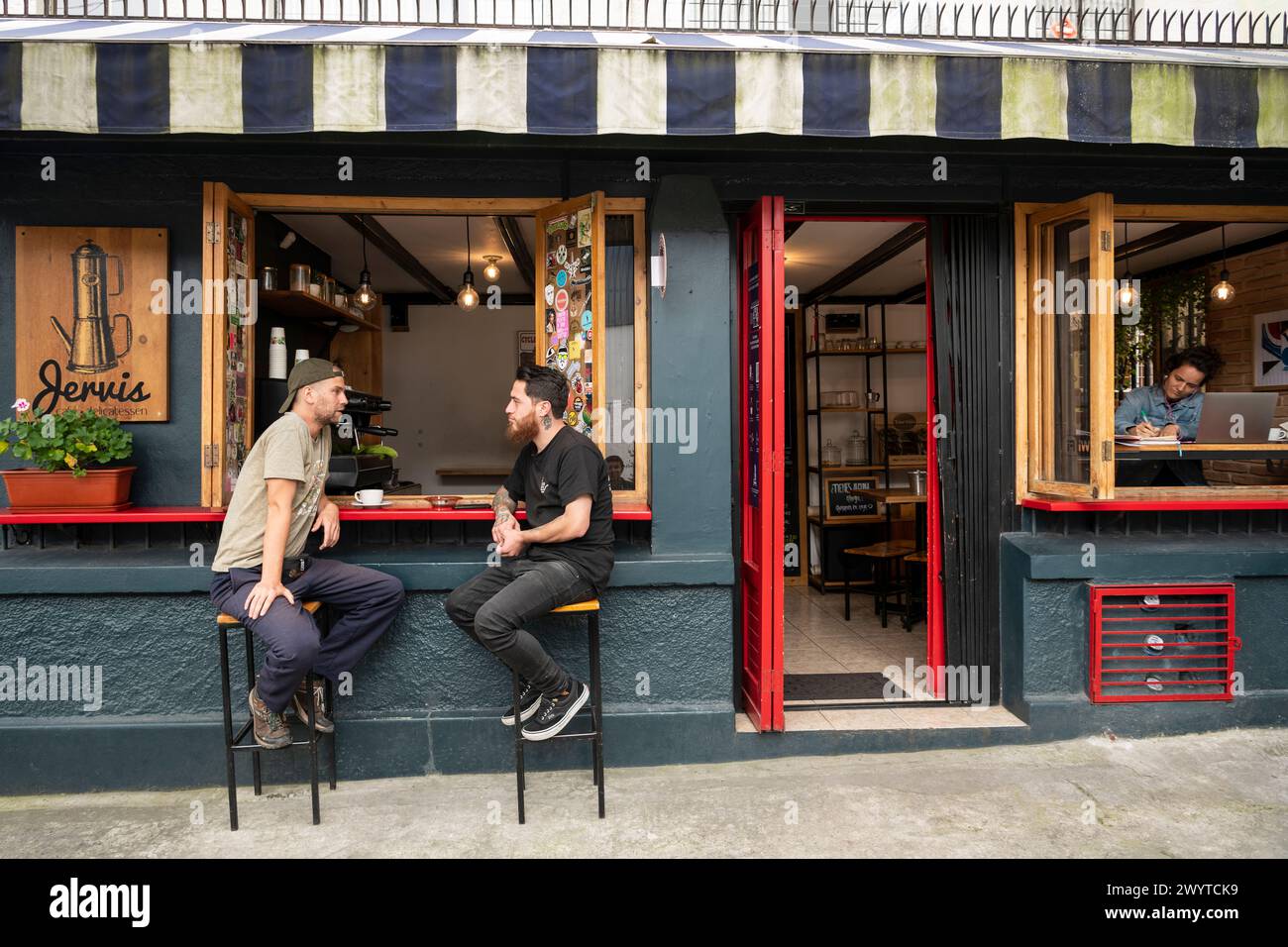 Men sitting outside cafe, La Floresta, Quito, Pichincha, Ecuador Stock