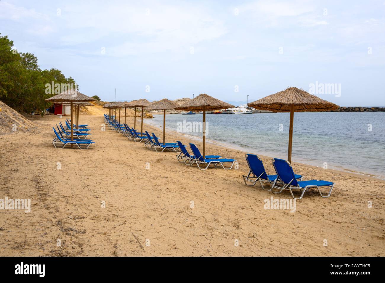 Sun loungers on sandy Limnionas beach. Kos island, Dodecanese, Greece Stock Photo