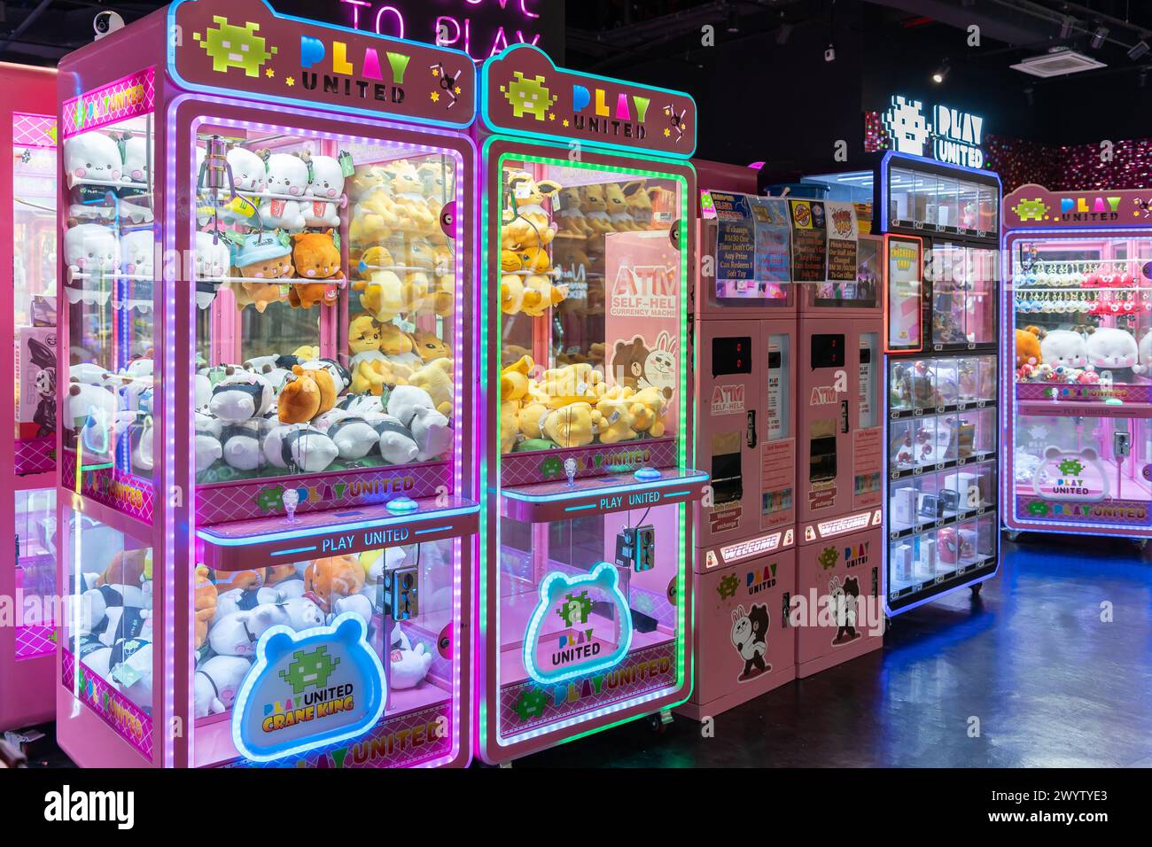 Kuala Lumpur, Malaysia - April 6,2024 : Colorful arcade game toy claw crane machine where people can win toys and other prizes Stock Photo