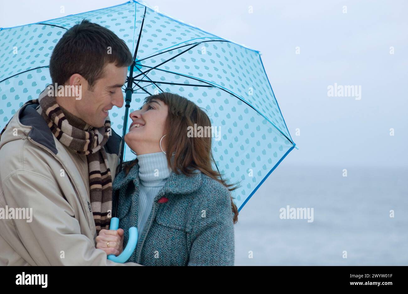 Couple sharing umbrella in rain hi-res stock photography and images - Alamy