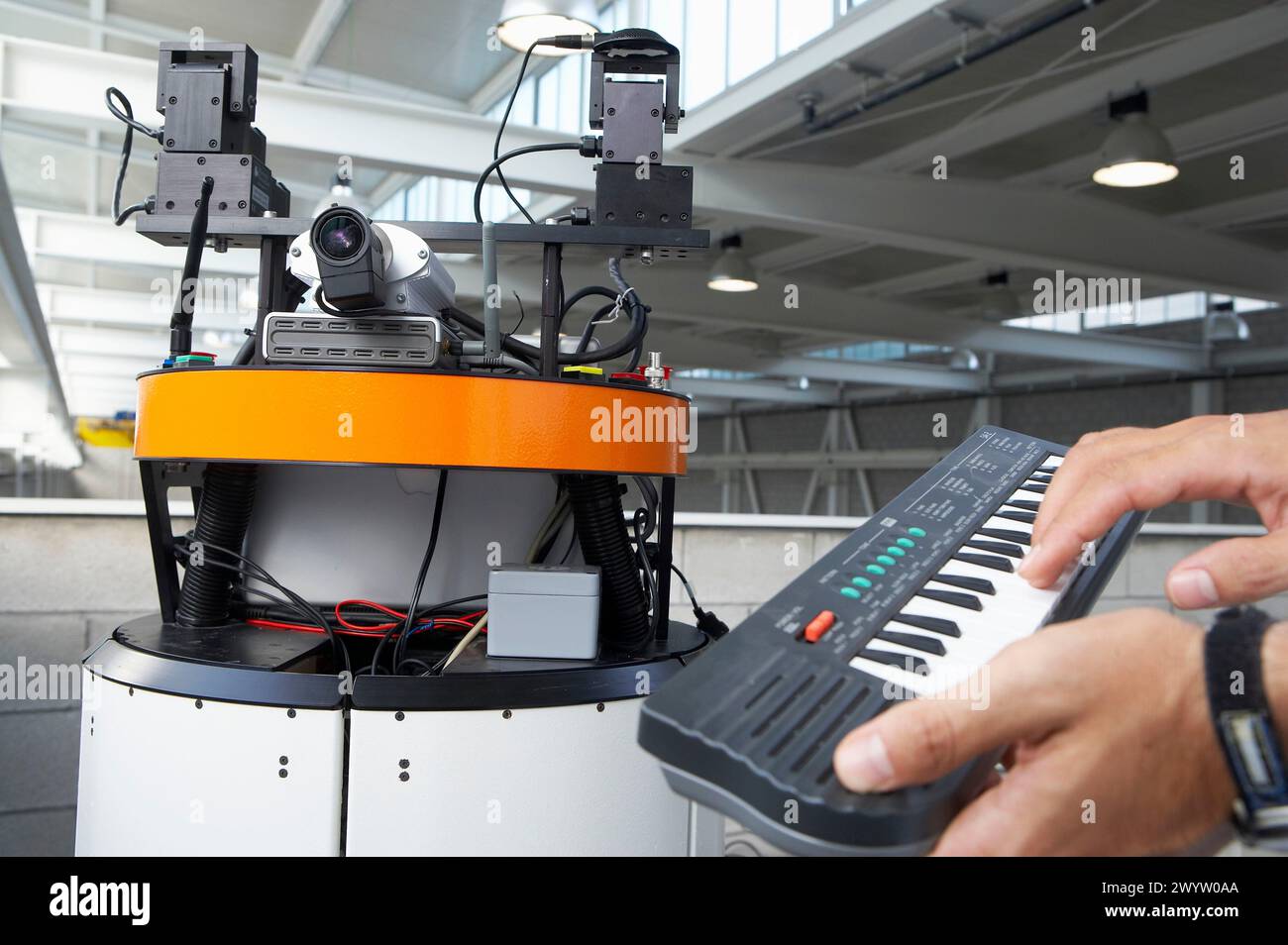 Researcher with music keywboard operating Robot Mirela, Fundacion Fatronik, Centro de Investigacion Tecnologica, Donostia, San Sebastian, Gipuzkoa, Basque country, Spain. Stock Photo