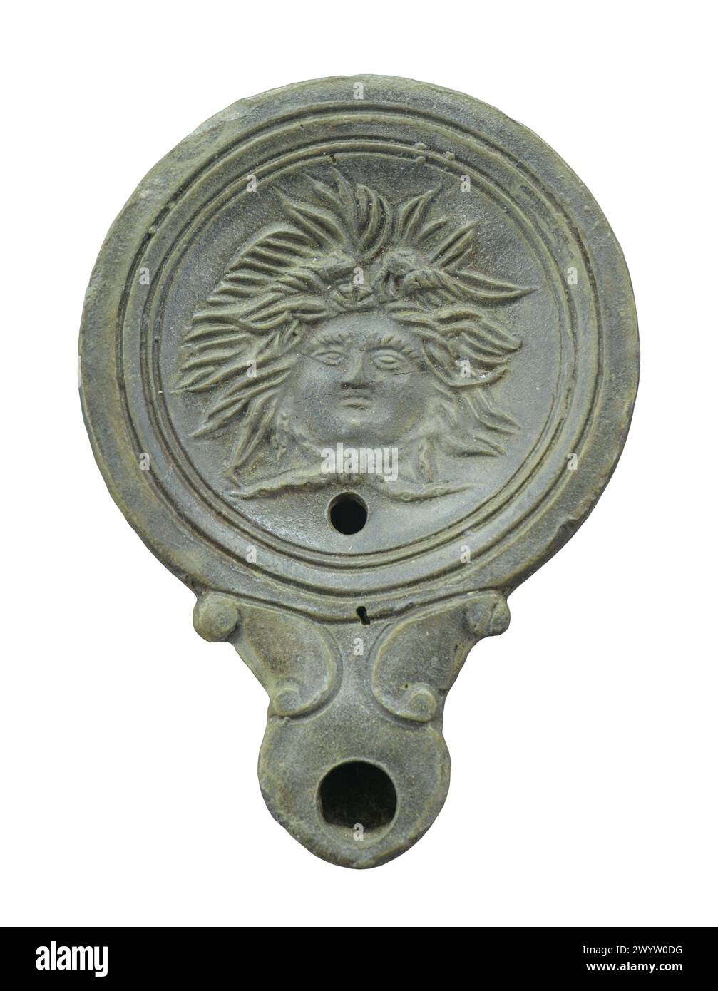 Ancient Roman oil lamp with the head of Medusa Gorgon. Isolated Stock Photo