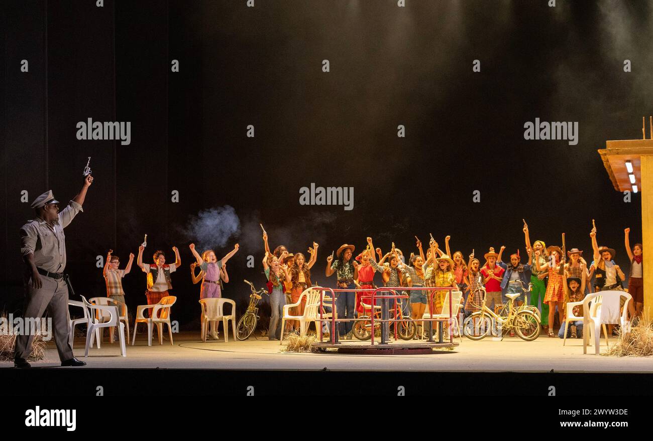 left: Blaise Malaba (Zuniga) with children's chorus in CARMEN at the Royal Opera House, Covent Garden, London WC2  05/04/2024 music: Georges Bizet  libretto: Henri Meilhac & Ludovic Halevy  dramaturg: Elisa Zaninotto  conductor: Antonello Manacorda  set design: Paulo Fantin  costumes: Carla Teti  lighting: Alessandro Carletti  director: Damiano Michieletto Stock Photo