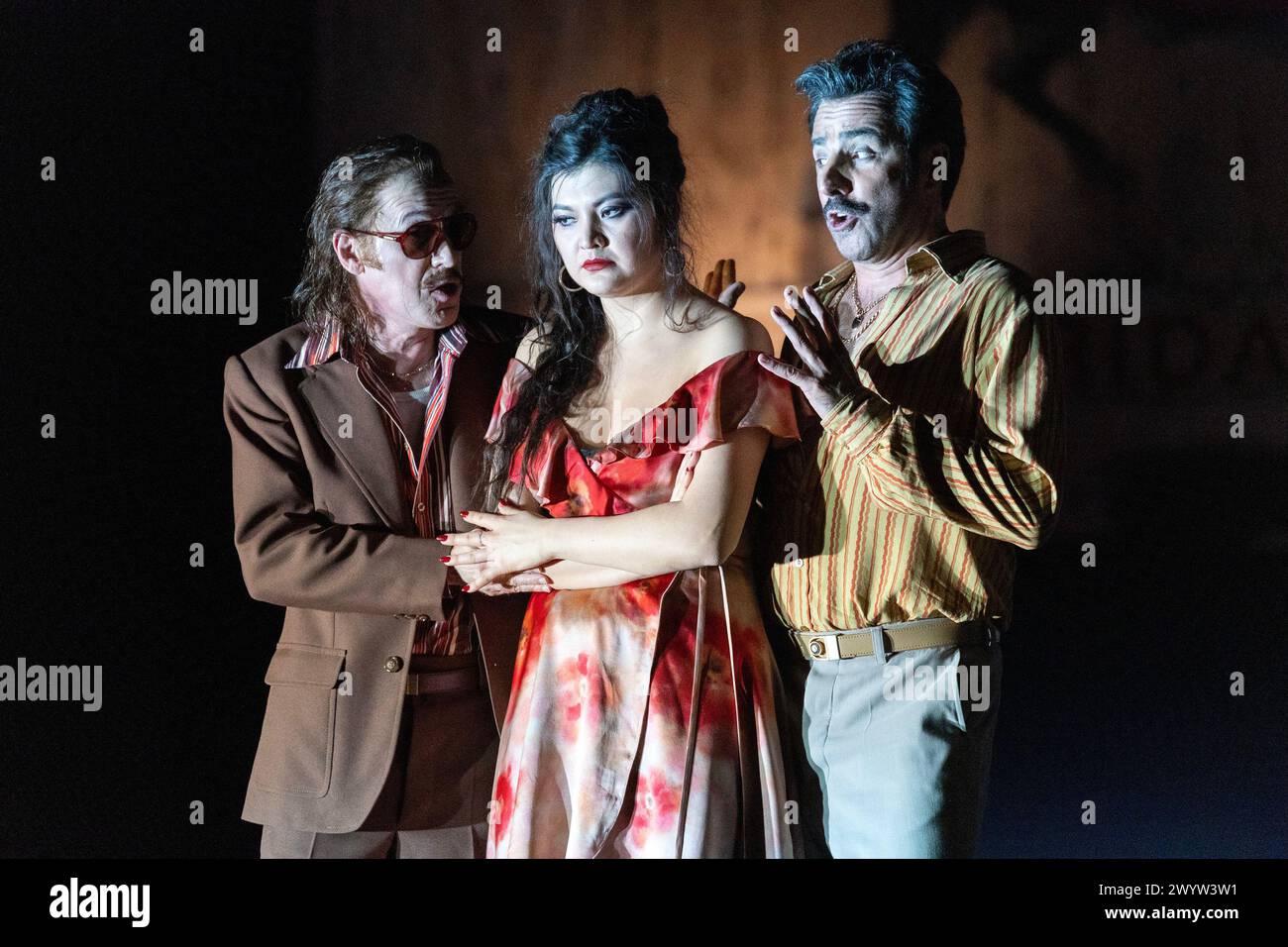 l-r: Vincent Ordonneau (Remendado), Aigul Akhmetshina (Carmen), Pierre Doyen (Dancairo) in CARMEN at the Royal Opera House, Covent Garden, London WC2  05/04/2024 music: Georges Bizet  libretto: Henri Meilhac & Ludovic Halevy  dramaturg: Elisa Zaninotto  conductor: Antonello Manacorda  set design: Paulo Fantin  costumes: Carla Teti  lighting: Alessandro Carletti  director: Damiano Michieletto Stock Photo