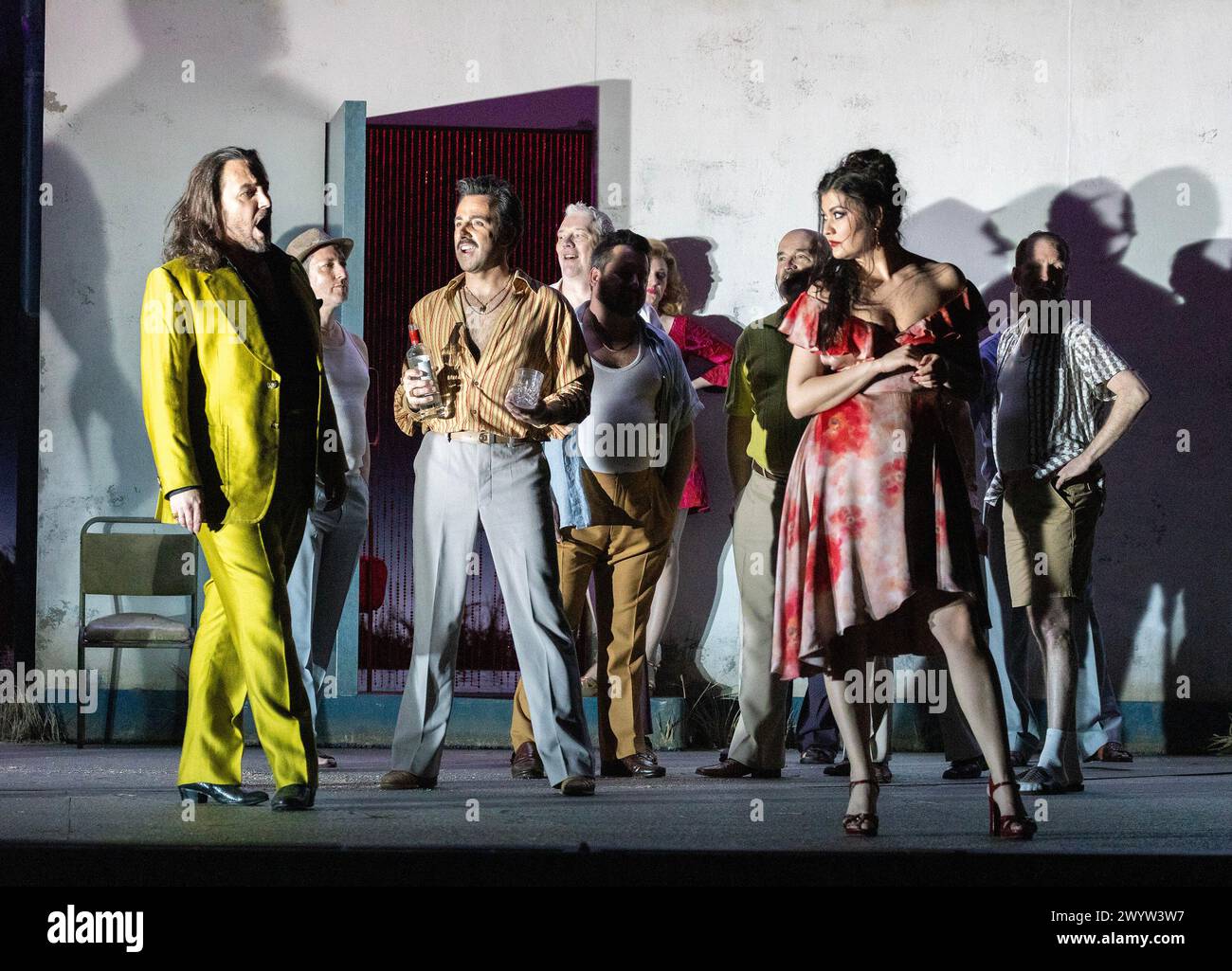 front, l-r: Kostas Smoriginas (Escamillo), Pierre Doyen (Dancairo), Aigul Akhmetshina (Carmen) in CARMEN at the Royal Opera House, Covent Garden, London WC2  05/04/2024 music: Georges Bizet  libretto: Henri Meilhac & Ludovic Halevy  dramaturg: Elisa Zaninotto  conductor: Antonello Manacorda  set design: Paulo Fantin  costumes: Carla Teti  lighting: Alessandro Carletti  director: Damiano Michieletto Stock Photo