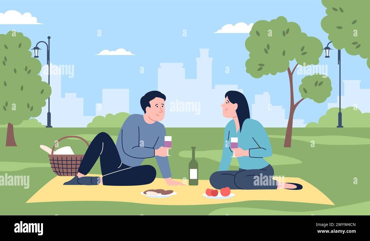 Couple on picnic. Young man and woman eating and drinking outdoor