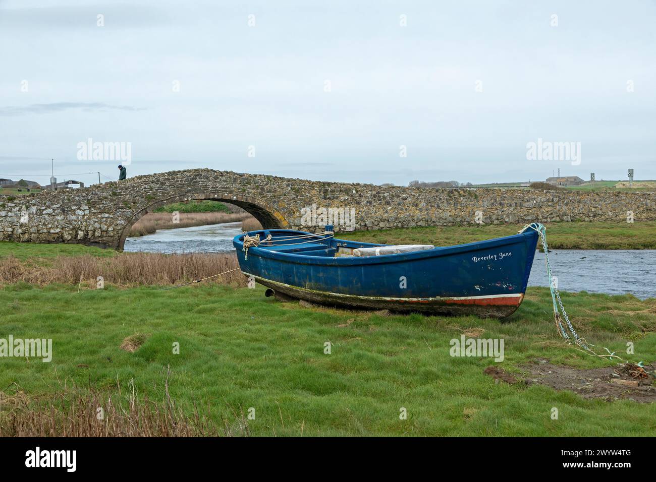 Stone bridge, fishing boat, person, Aberffraw, Anglesey Island, Wales, Great Britain Stock Photo