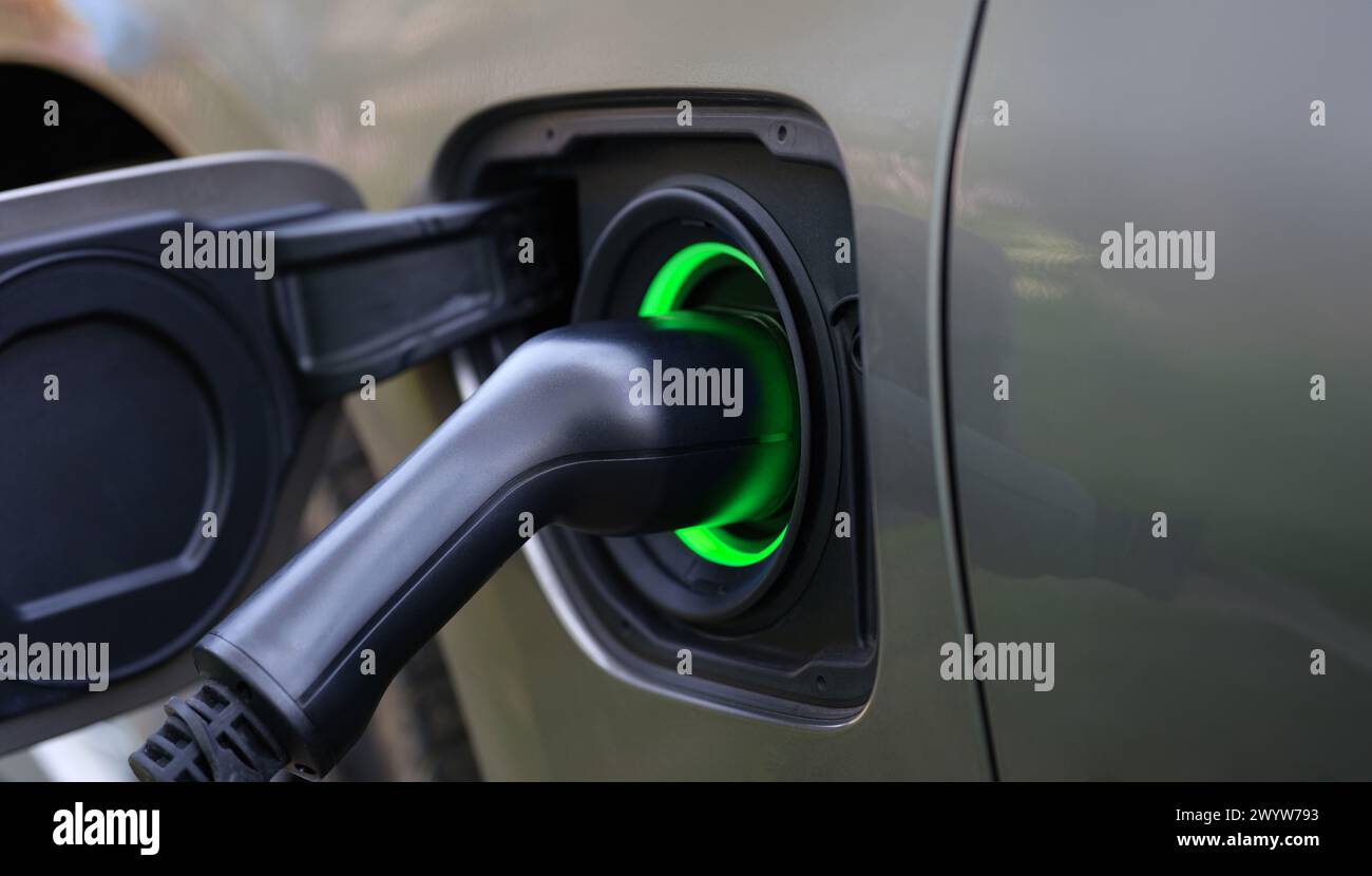 Electric car and charging at charging station closeup Stock Photo - Alamy