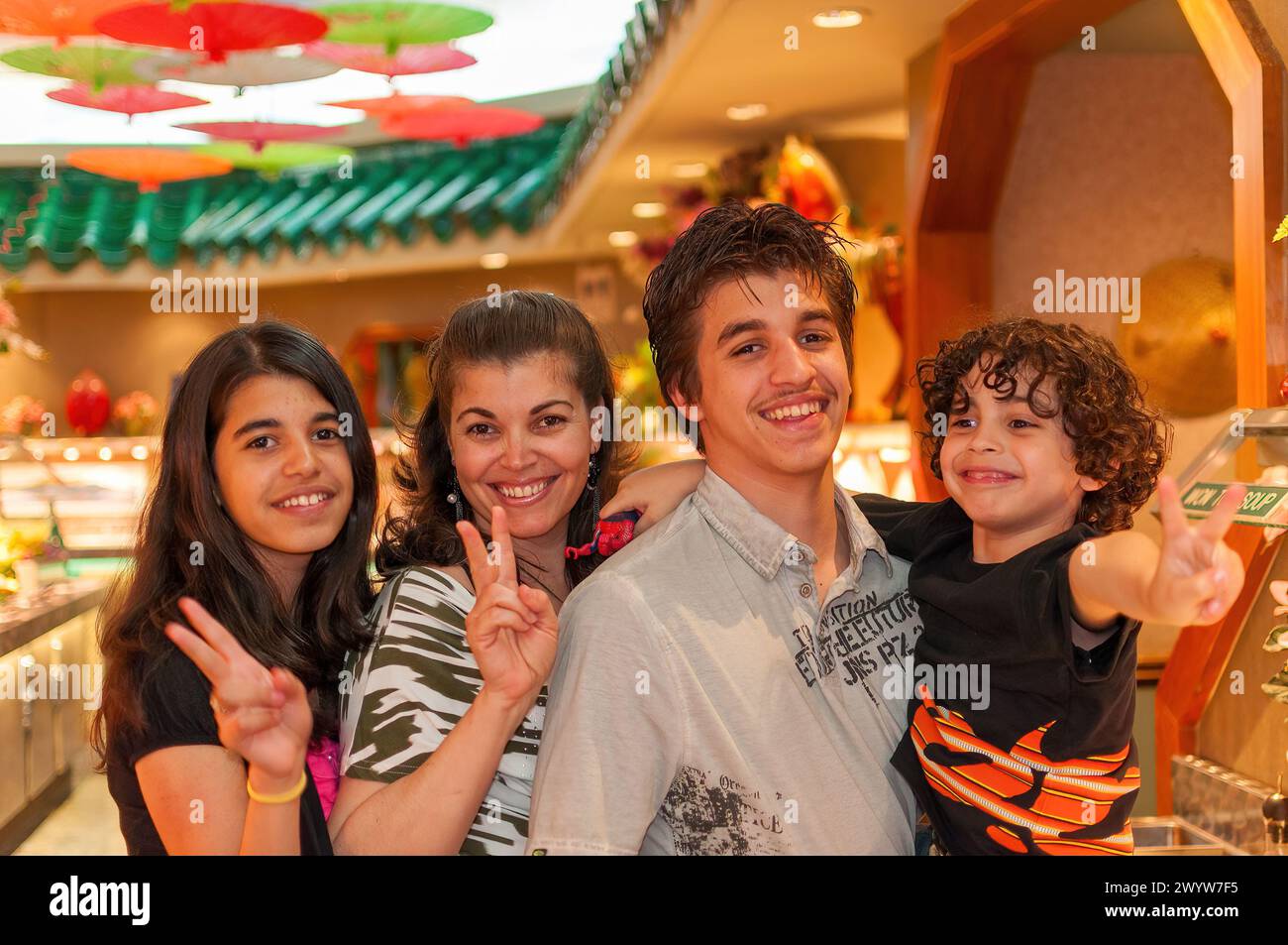 portrait of latin american family in a buffet restaurant Stock Photo