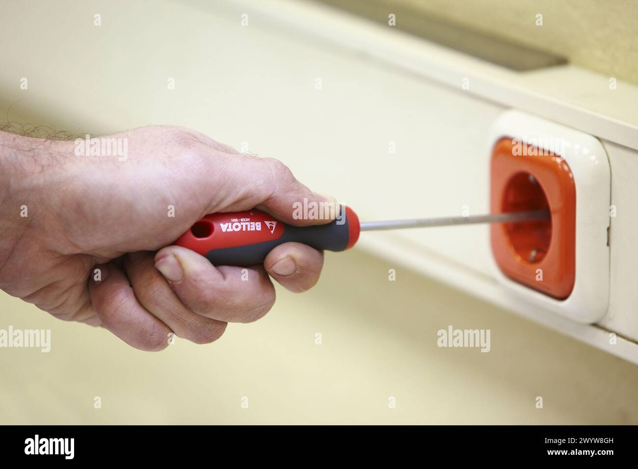 Fixing socket with screwdriver. Stock Photo