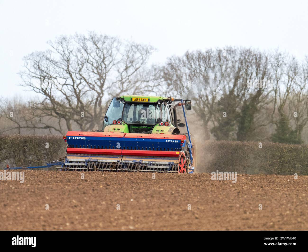 A farmer tilling soil near Cley in Norfolk, UK. Stock Photo
