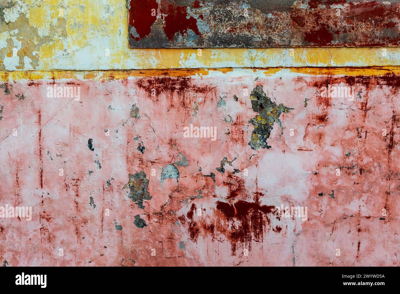 Old wall, peeling ocher and uellow paint colorful texture Stock Photo