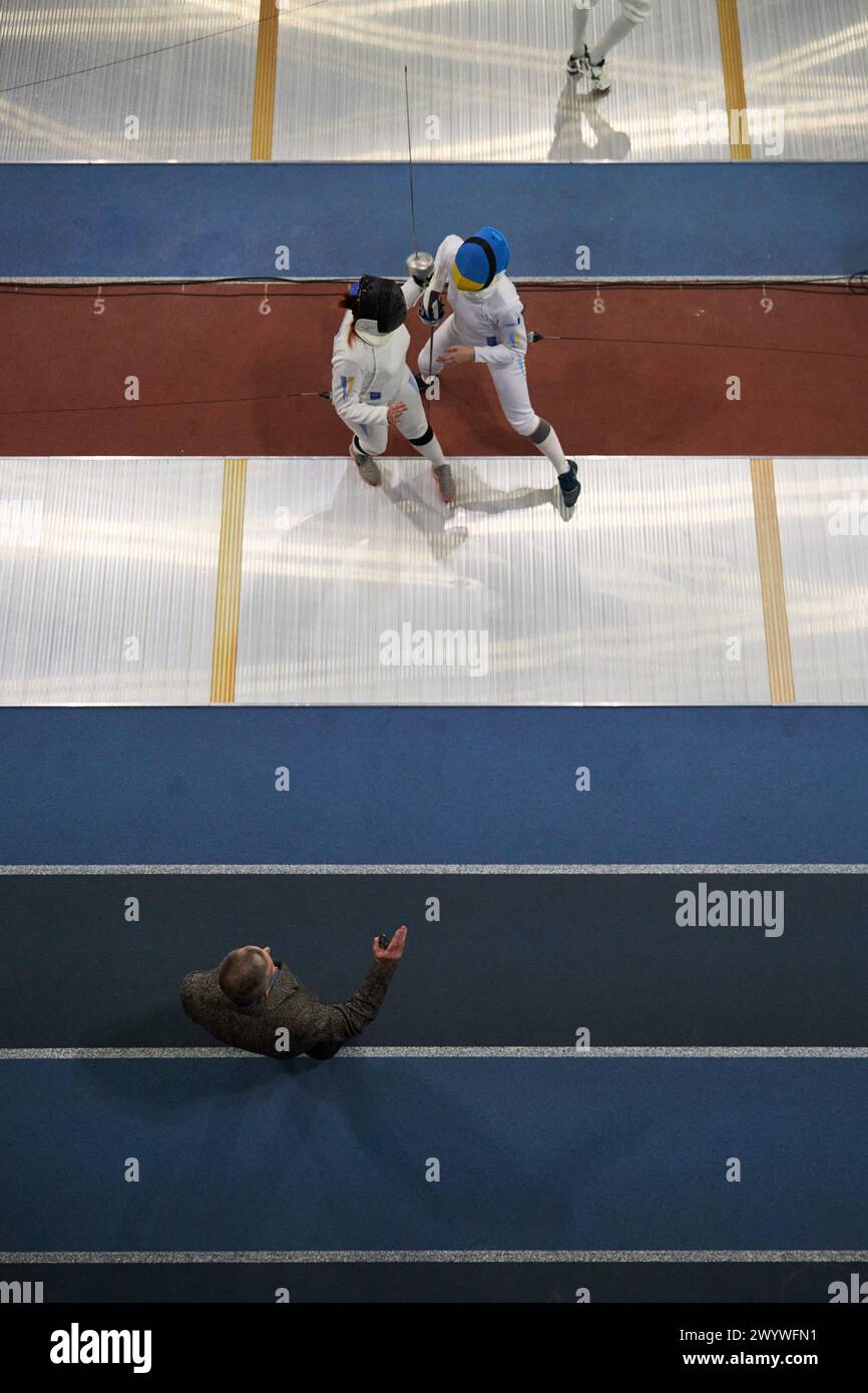 Judge judges two professional fencers at the National Fencing Championship of Ukraine, photographed from above. Kyiv - 30 March,2024 Stock Photo