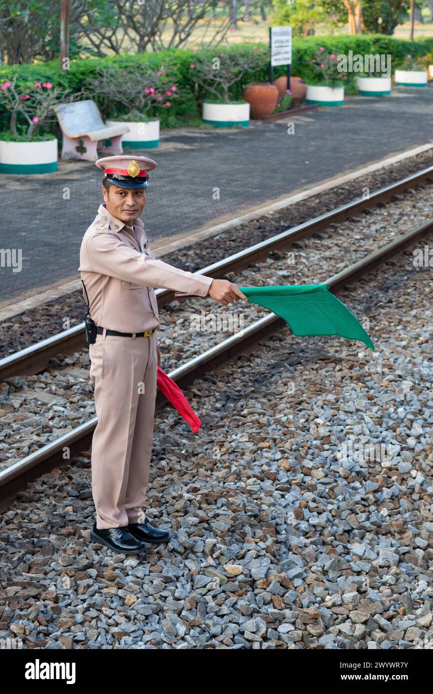 CHA AM, THAILAND - DECEMBER 13, 2018: The train station attendant gives the command for the train to depart Stock Photo