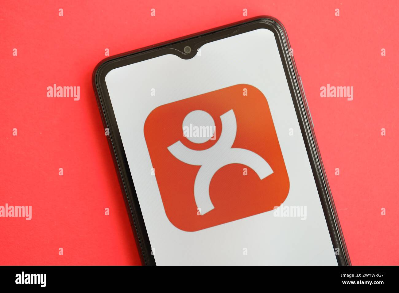KYIV, UKRAINE - APRIL 1, 2024 Dianping platform icon on smartphone screen on red table close up. iPhone display with app logo on bright red background Stock Photo