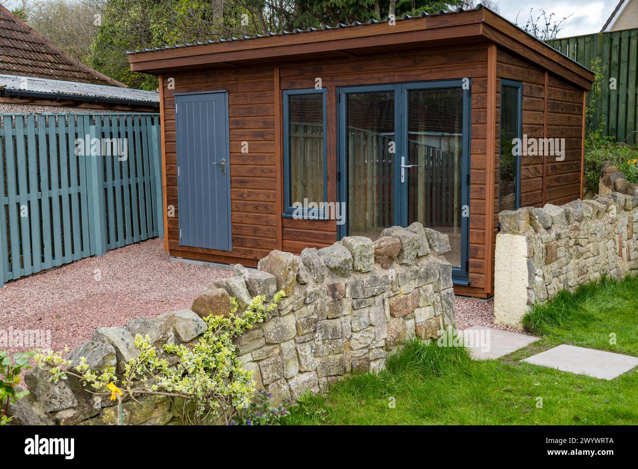 A shed and garden room or summerhouse newly built in a driveway, Scotland, UK Stock Photo