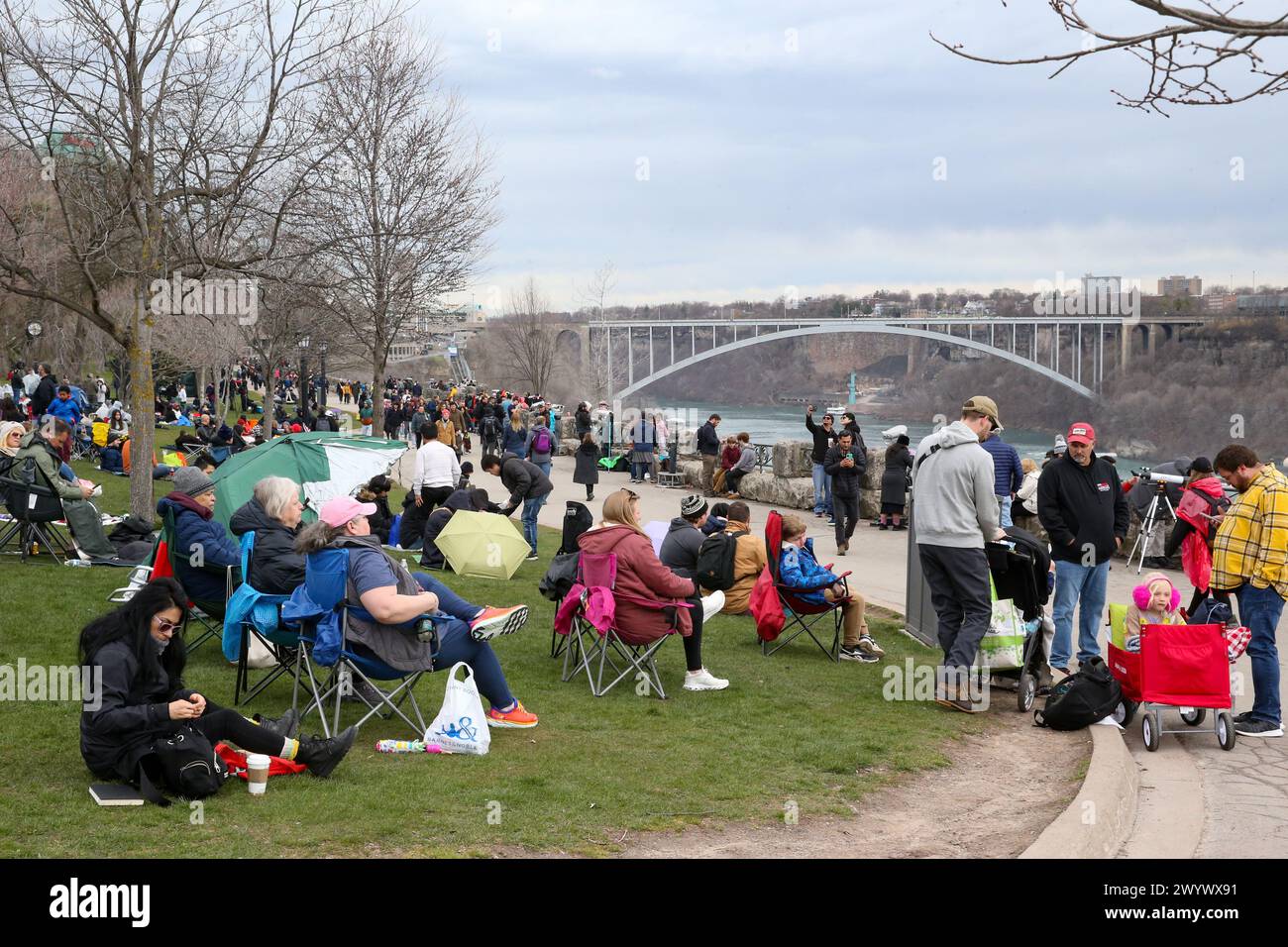 Niagara Falls, Canada. 8th Apr, 2024. Queen Victoria Park in Niagara Falls Ontario is a gathering spot for the 2024 Solar Eclipse. People start to gather 2 hours early,  Niagara Falls is expecting more than a million people to show up to view Solar Eclipse on an overcast day.  Credit: Luke Durda/Alamy Live News Stock Photo