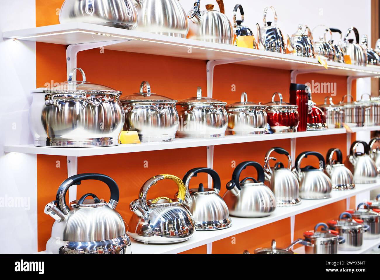 Enameled kitchen stock pots and teapots in the store Stock Photo Alamy