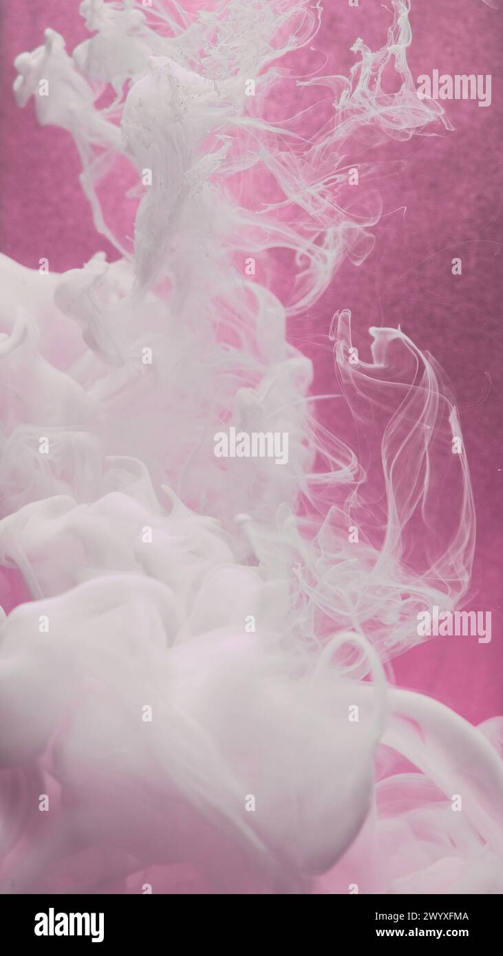 Smoke art. Paint water swirl. Ink cloud. White silk acrylic liquid flow texture haze motion on defocused pink color grain abstract background. Stock Photo