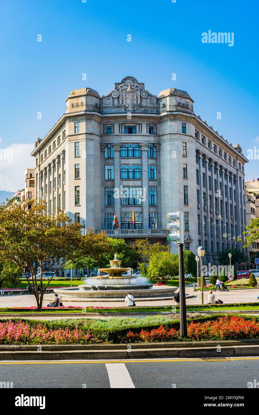 Building of the State Tax Administration Agency with the coat of arms of Spain used during the Franco dictatorship on the facade. Moyúa square or Elli Stock Photo