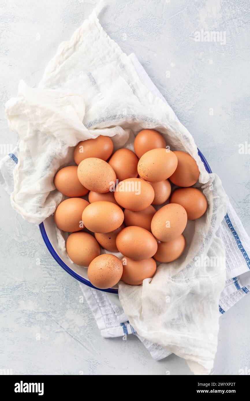 Fresh organic eggs on kitchen table Stock Photo