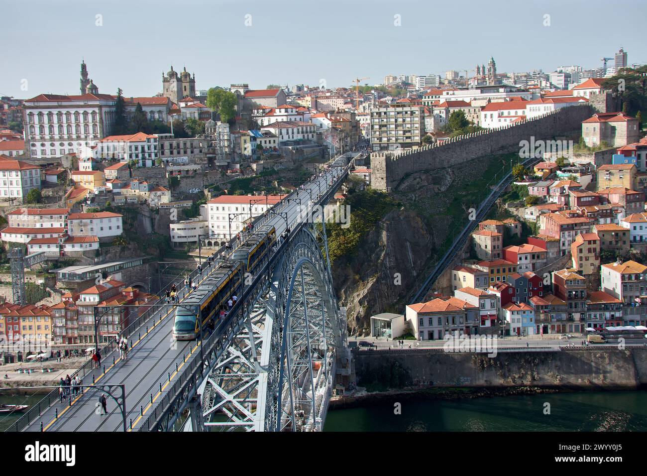 Porto,Portugal; March, 28,2022; Dom Luis Iron Bridge at sunset with the metro passing through it and the houses of Porto Stock Photo