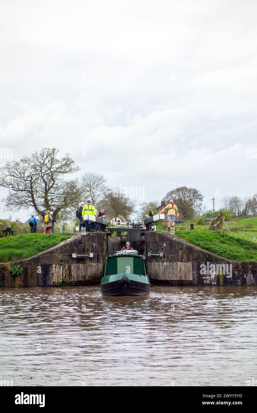 Canal narrowboat emerging from the  locks of the Llangollen canal on to the Shropshire union canal at Hurleston junction near Nantwich Cheshire Stock Photo