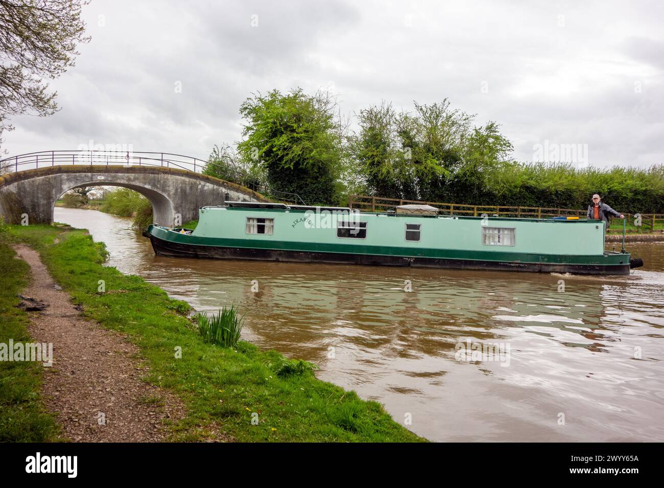 Canal narrowboat about to make the turn South towards Nantwich on the Shropshire Union canal after emerging from the Llangollen at Hurleston junction Stock Photo