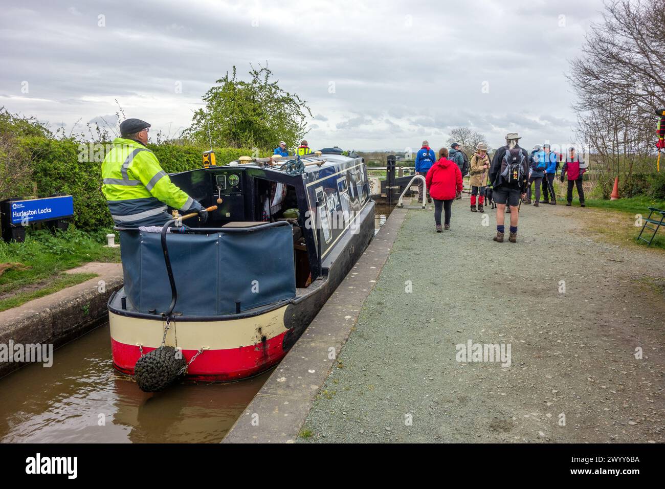 Man on a canal narrowboat passing through Hurleston junction locks on the Llangollen canal before joining the Shropshire union canal Stock Photo