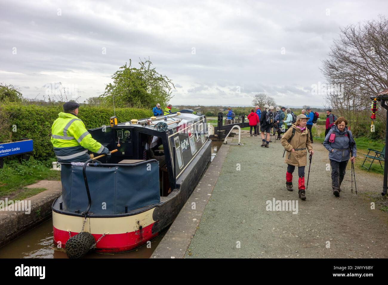 Man on a canal narrowboat passing through Hurleston junction locks on the Llangollen canal before joining the Shropshire union canal Stock Photo