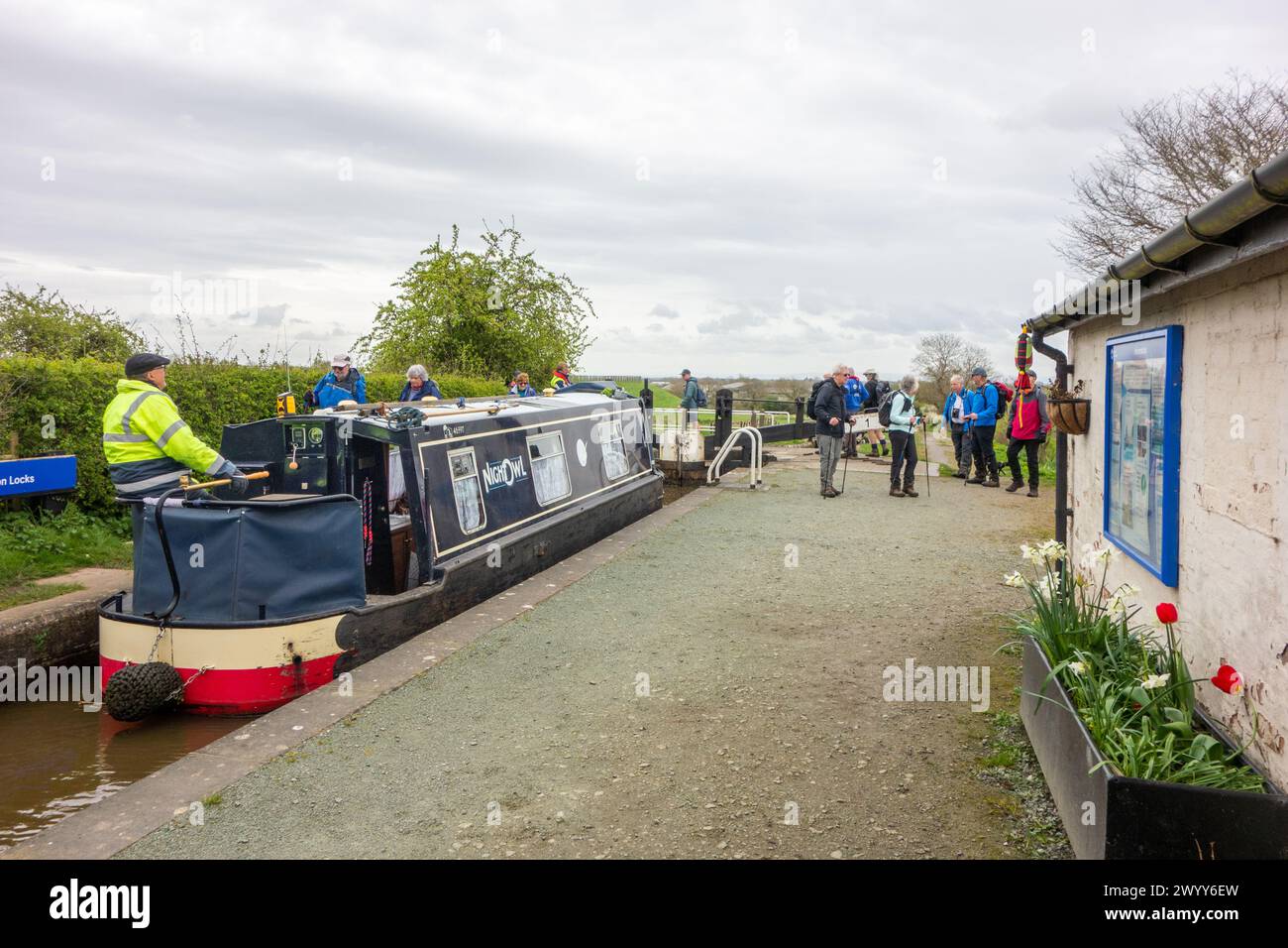 Man on a canal narrowboat passing through Hurleston junction locks on the Llangollen canal before joining the Shropshire union canal Stock Photo