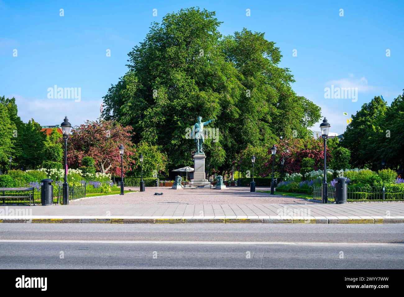 Karl XII, the Swedish kings statue stands commanding in Kungstradgarden, Stockholm, amidst the lush greenery on a clear day. Sweden Stock Photo