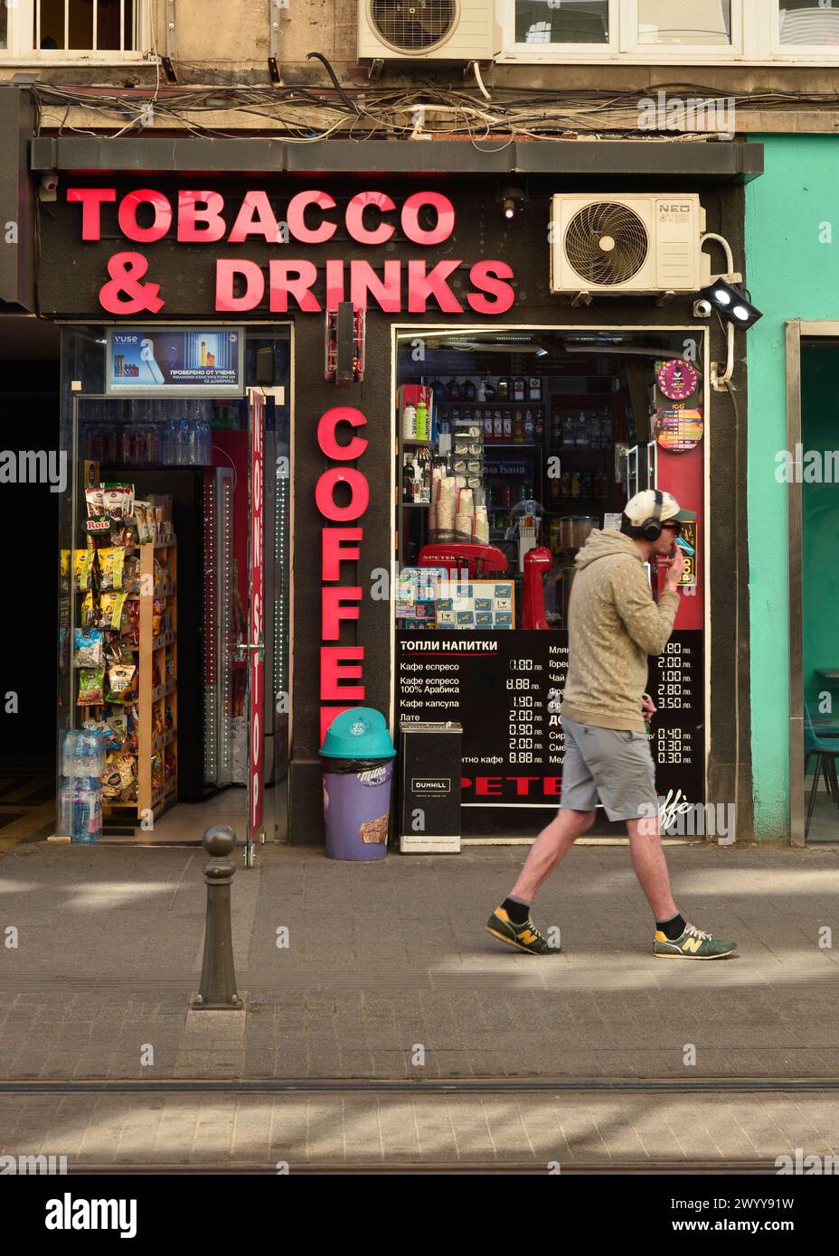 Off-licence shop with pink text tobacco, drinks, coffee in Sofia Bulgaria, Eastern Europe, Balkans, EU Stock Photo
