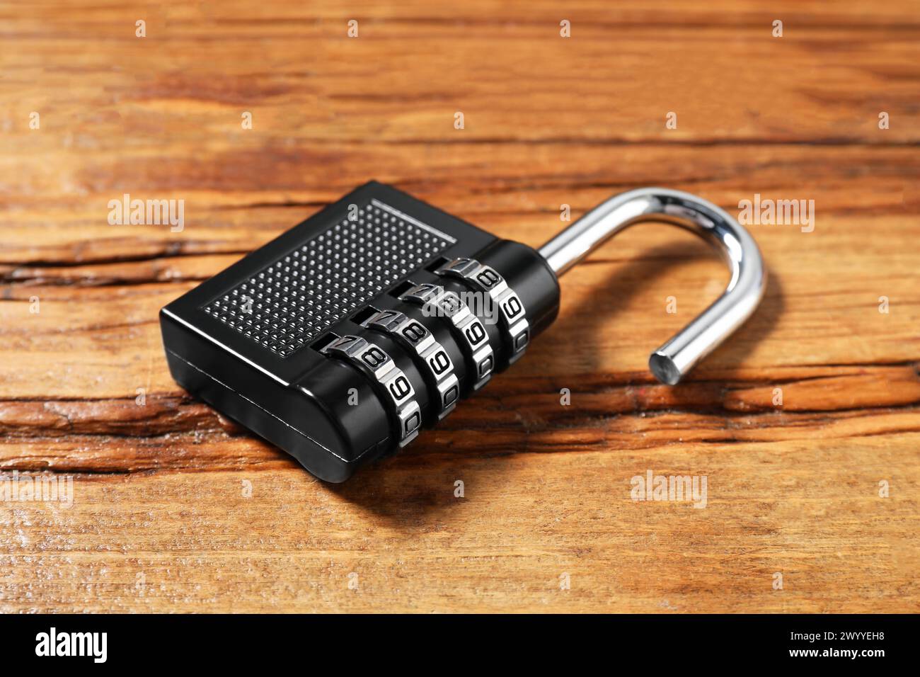 One steel combination padlock on wooden table, closeup Stock Photo - Alamy