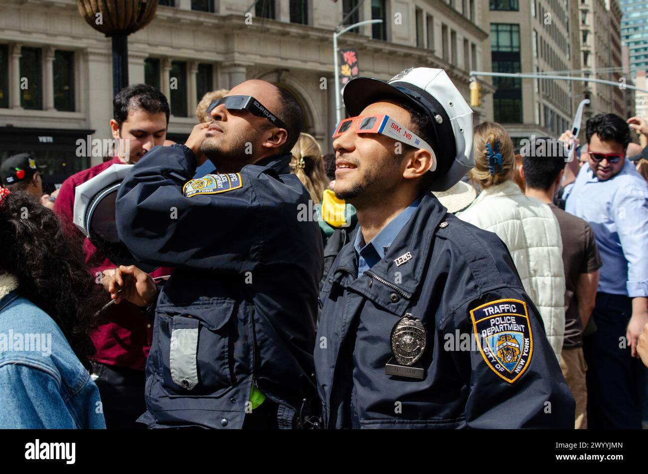New York City, USA. 08th Apr, 2024. NYPD officers watch the solar ...