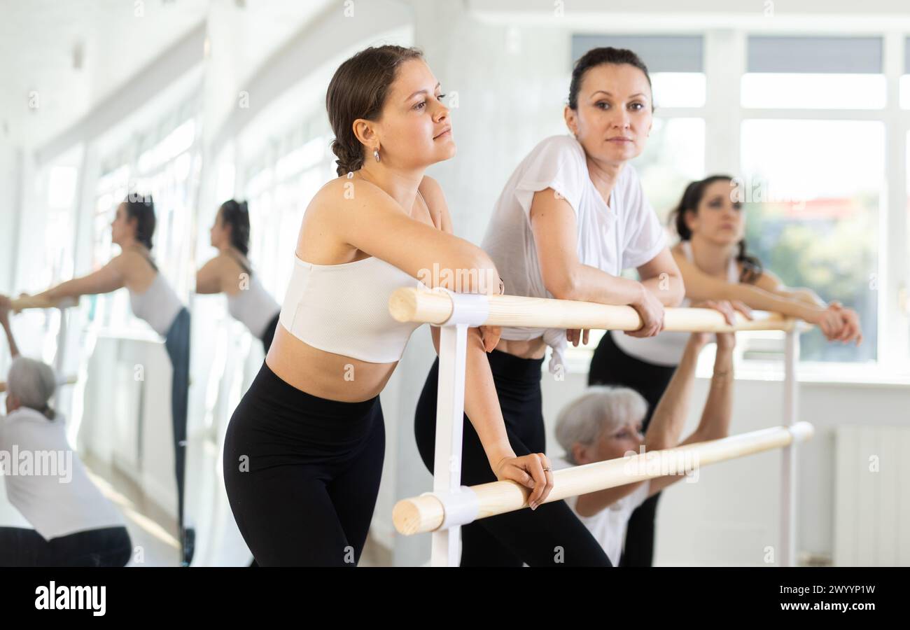 Ballerinas communicate with each other during a break between classes ...