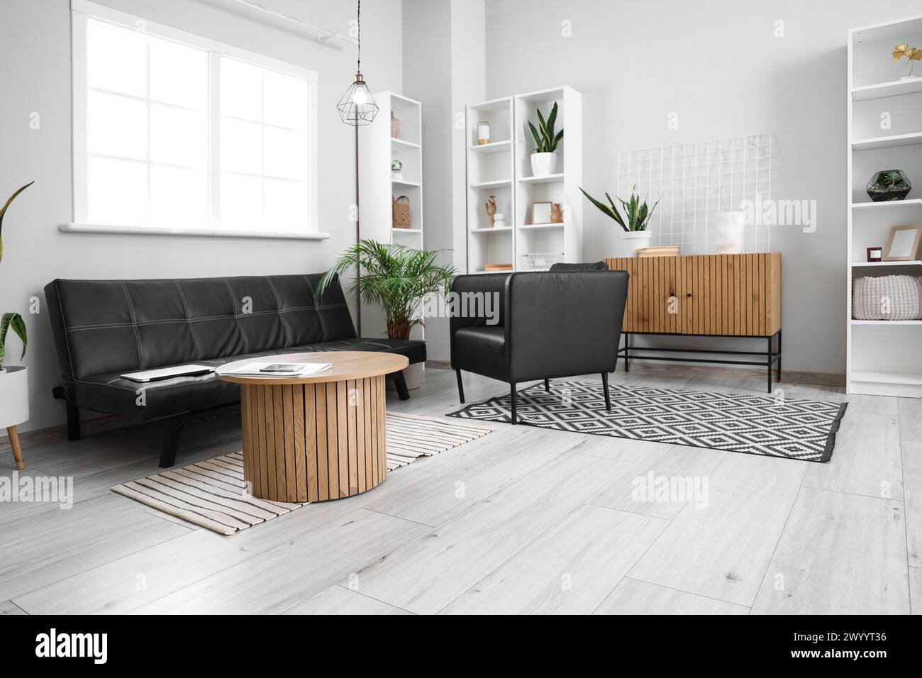 Interior of modern living room with black leather sofa and armchair ...