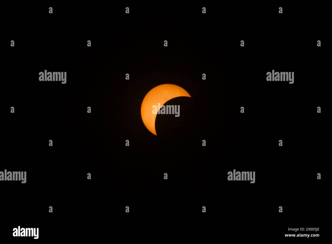 orange crescent showing in partial eclipse in the path of totality in Texas, 2024 Stock Photo